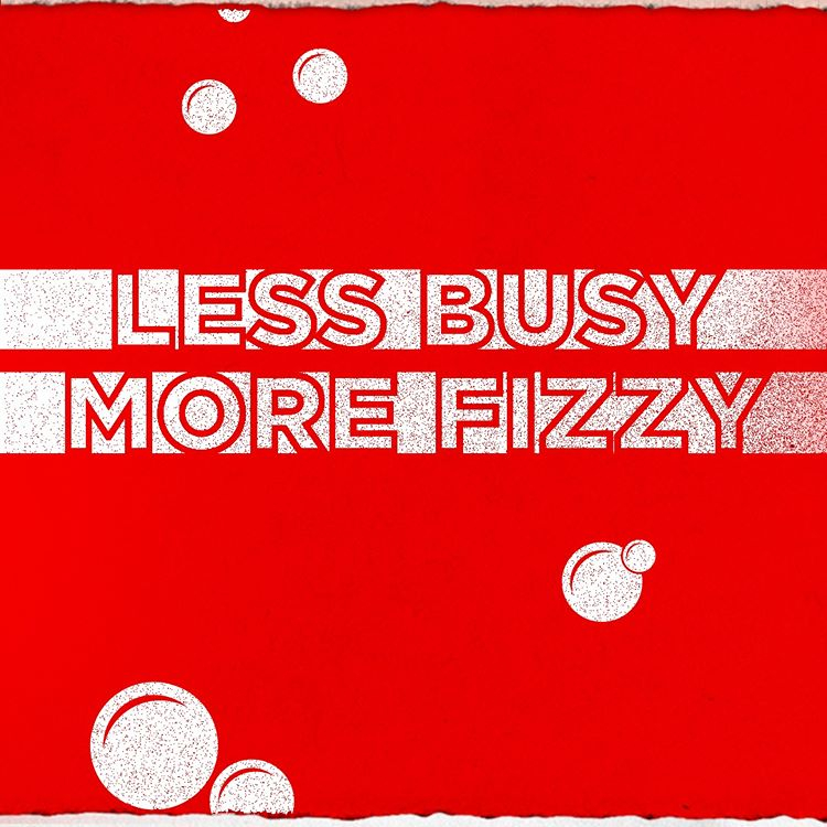 Text outlined in red over white bars on a red background with white bubbles: "LESS BUSY, MORE FIZZY." From Coca-Cola's Instagram page.
