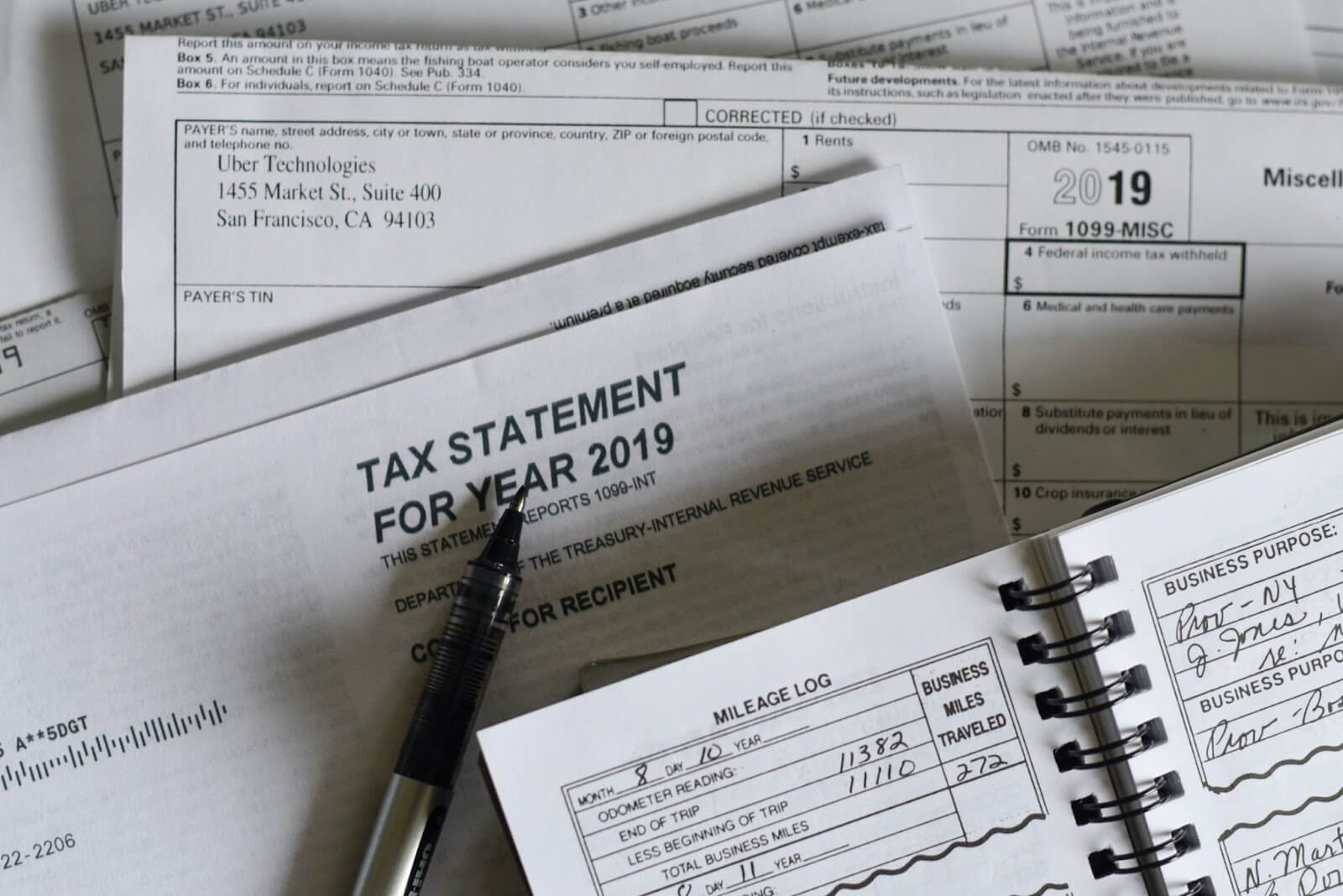 A pile of financial documents and tax statement on top of each other