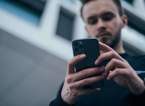Man holding an iPhone with two hands.
