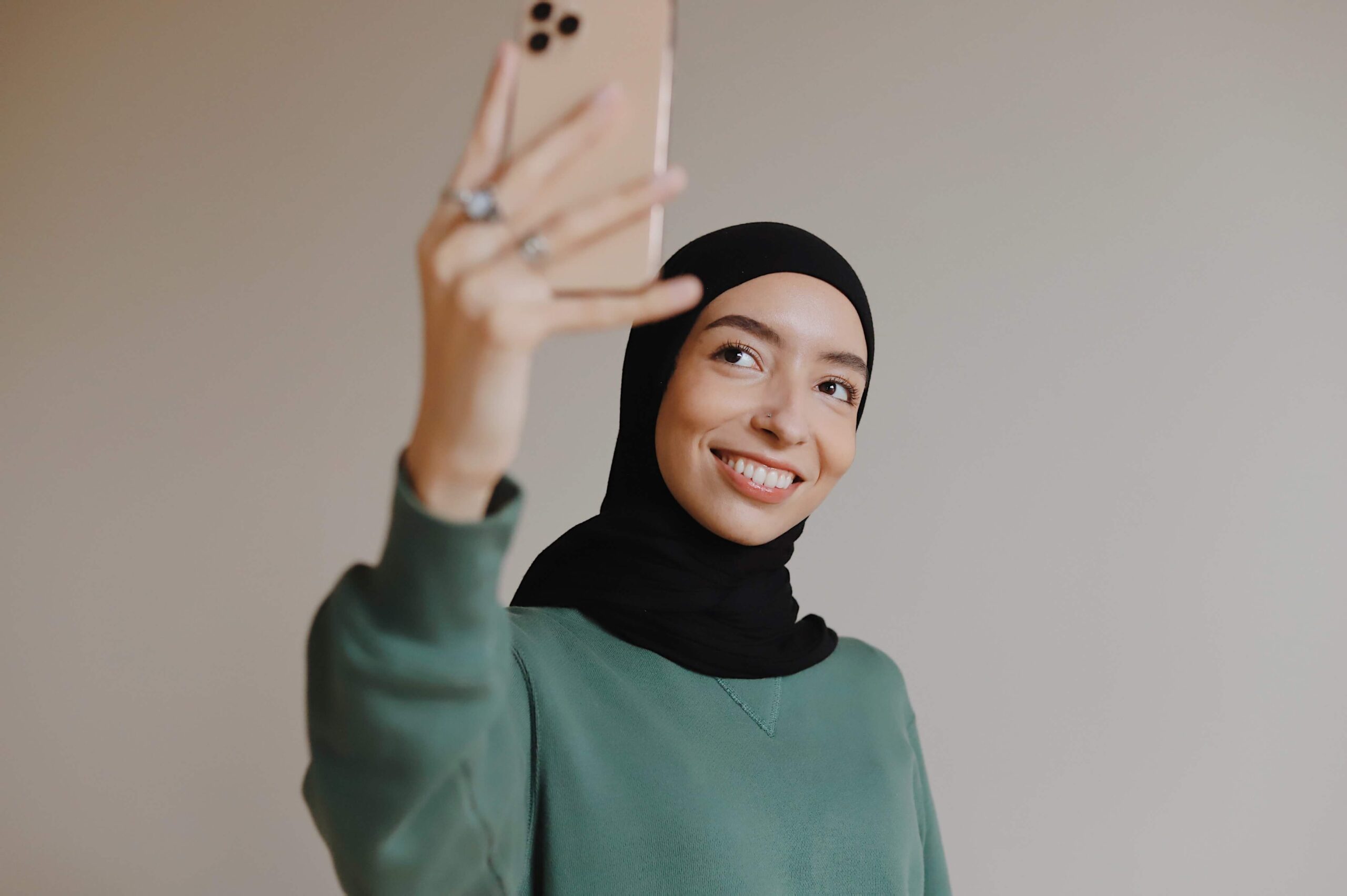 A woman holding a phone and taking a selfie.